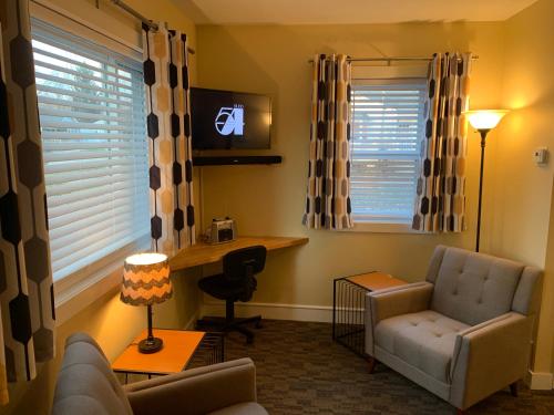 a living room with a couch and a chair and a desk at Cottage11 of Avalon -2 Bedroom-1 Bath- Laundry- Sleeps 6 in Lansing