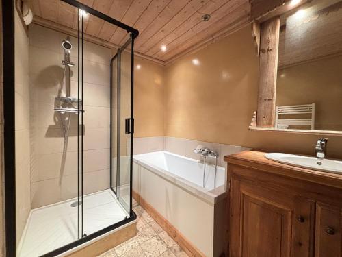 a bathroom with a shower and a tub and a sink at Appartement 3 pièces jusqu'à 6 pers, Méribel centre, proche pistes et commerces - FR-1-411-68 in Les Allues