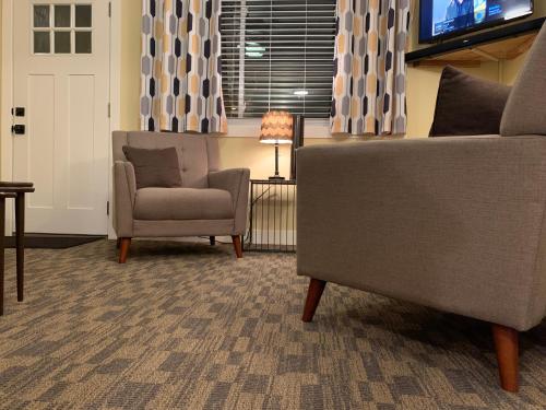 a living room with a chair and a television at Cottage11 of Avalon -2 Bedroom-1 Bath- Laundry- Sleeps 6 in Lansing