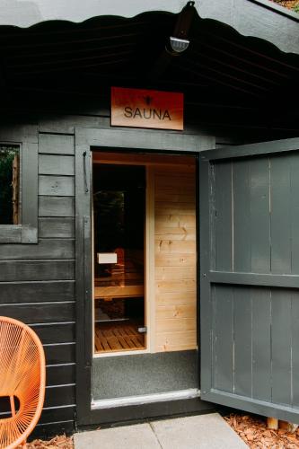 a sarmaarma restaurant with a sign on the front of a building at Bumblebee Cabin in Diessen