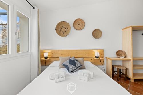 a bedroom with a white bed with pillows on it at Sa Stadda in Lanusei