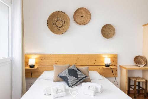 a bedroom with a white bed with pillows on it at Sa Stadda in Lanusei