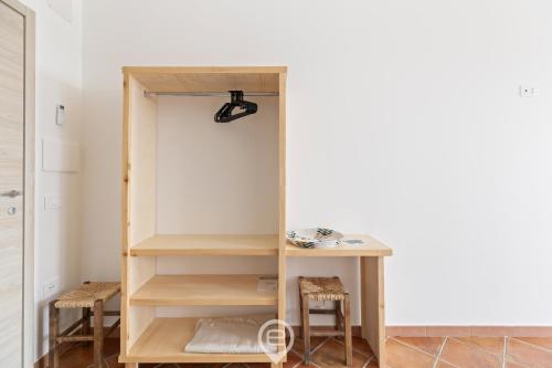 a room with a closet with a desk and stools at Sa Stadda in Lanusei