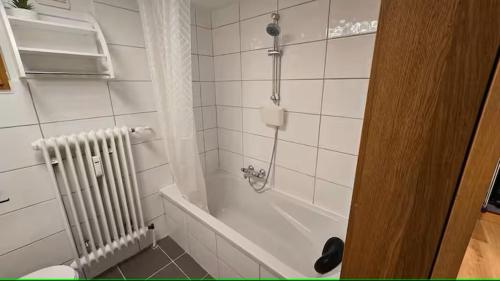 a bathroom with a white tub and a radiator at Ferienwohnung Klein in Schönau am Königssee
