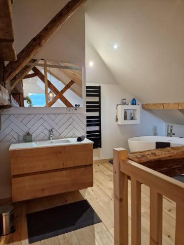une salle de bain avec un lavabo et une baignoire dans l'établissement Duplex la Beun, à Saint-Paul-en-Chablais