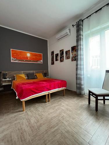 a bedroom with a bed with a red blanket at Da Irene in Sassari