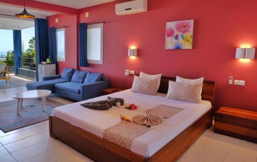 Postel nebo postele na pokoji v ubytování Hôtel Villa Les Orchidées