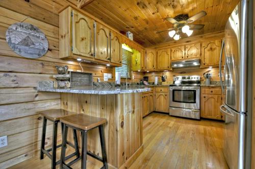 a kitchen with wooden cabinets and a counter with a refrigerator at 3 BR Mountain Cabin Games Hot Tub Fire Pit in Morganton