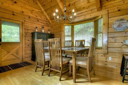 a dining room with a table and chairs in a cabin at 3 BR Mountain Cabin Games Hot Tub Fire Pit in Morganton