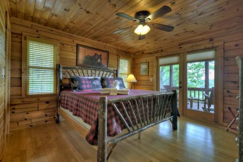 a bedroom with a bed in a log cabin at 3 BR Mountain Cabin Games Hot Tub Fire Pit in Morganton