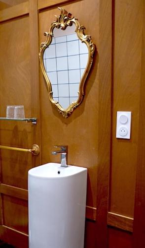 a bathroom with a toilet with a mirror on the wall at La Martanne in Argelès-sur-Mer