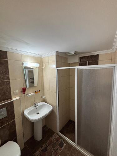 a bathroom with a shower and a sink at Metropolitan apart in Marmaris
