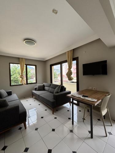a living room with a couch and a table at Metropolitan apart in Marmaris