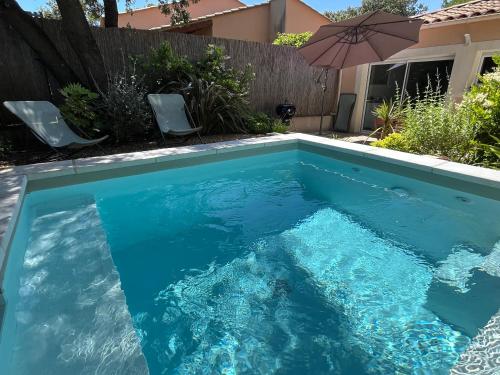 une piscine avec de l'eau bleue dans une cour arrière dans l'établissement Magnifique villa avec piscine en Provence, à Bédarrides