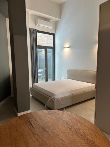 a bedroom with a bed and a large window at Effealatapartments - EdenLoft in Senigallia