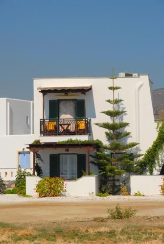 a white building with a christmas tree in front of it at Sea Melody Studios in Plaka