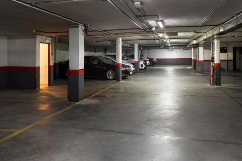an empty parking garage with cars parked in it at Sercotel Togumar in Madrid