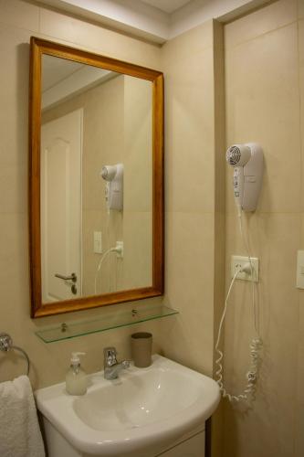 a bathroom with a sink and a mirror at Del Santo San Rafael in Puerto Madryn