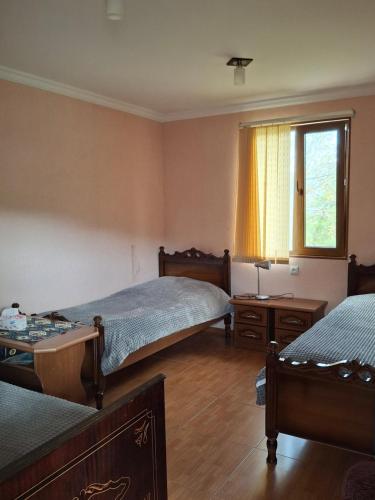 a bedroom with two beds and a window at Tatev 1 in Tatʼev