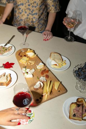 a table with plates of food and glasses of wine at Bellevigne Bourgogne in Chambolle-Musigny