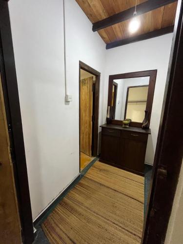 a hallway with a mirror and a bathroom at Margarita Village kite school kalpitiya in Kalpitiya