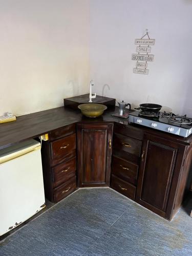a kitchen with a counter with a sink and a stove at Margarita Village kite school kalpitiya in Kalpitiya