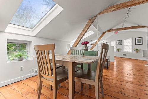 a dining room with a wooden table and chairs at Sunny Westport Studio Apt. Above Historic Mill in Westport