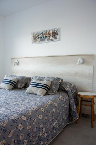 a bedroom with a bed and a table at Del Santo San Rafael in Puerto Madryn