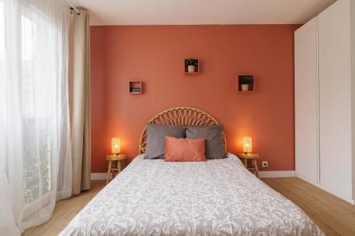 - une chambre aux murs orange et un lit avec deux lampes dans l'établissement Une Escapade au Vieux Port, à Marseille