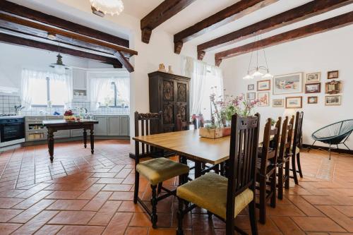 a kitchen and dining room with a wooden table and chairs at The Rustique - 3BED house in Mellieha by Homely! in Ix-Xagħra taʼ Barra