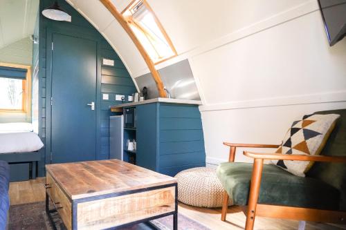 a small room with a couch and a table at Chawton Park Farm by Wigwam Holidays in Chawton
