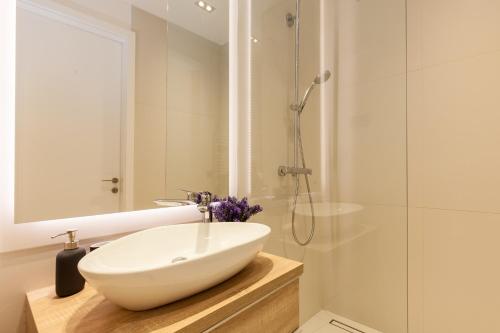a bathroom with a white sink and a shower at Boutique Apartment in Budapest Downtown in Budapest