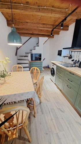 a kitchen with a table and chairs in a room at Antonio's home in Colonno