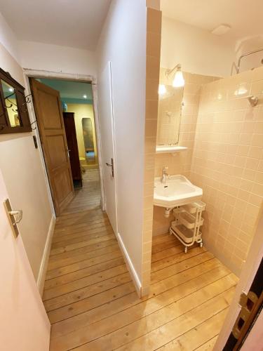 a bathroom with a sink and a mirror at TheVillaRose in Wimereux