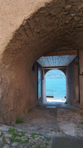 a tunnel leading to the ocean through a stone wall at Antonio's home in Colonno