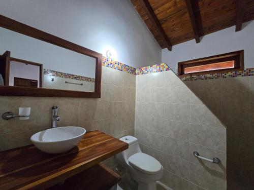 a bathroom with a sink and a toilet at Finca Hotel Galilea Doradal in Doradal