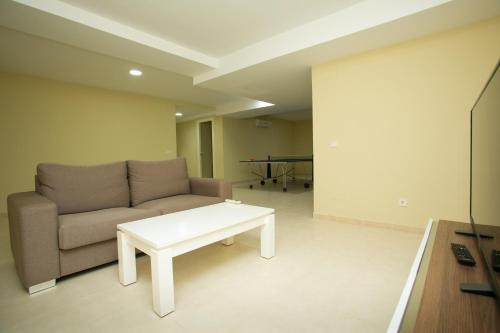 a living room with a couch and a coffee table at Villas Altos De Marbella in Marbella