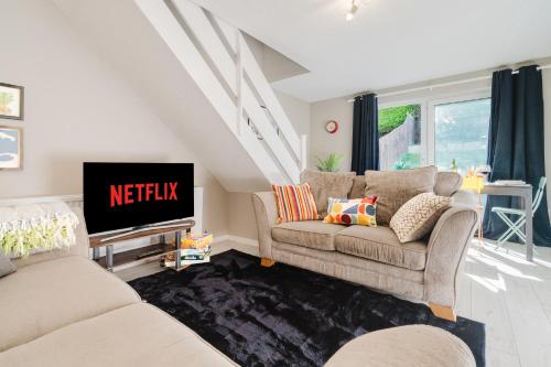 a living room with two couches and a tv at Quiet & Stylish 2-Bed House with Garden & Free Parking in Cwm-brân