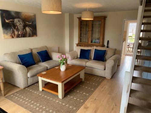 a living room with two couches and a coffee table at Beautiful home near to Musgrove Park Hospital in Taunton