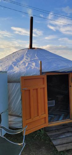 a yurt with a wooden cabinet in front of it at Tsaatan - Mother's Traditional Ger in Khyaktil