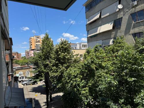 a view from the balcony of a building with trees at AL Apartments Tirana in Tirana