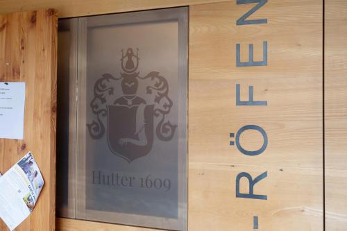 a sliding glass door with a emblem on it at Ansitz Röfen in Burgusio