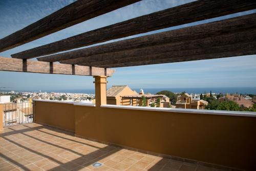 a roof deck with a view of the city at Villas Altos De Marbella in Marbella