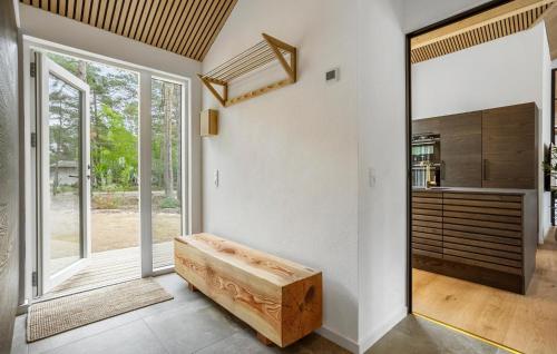 a living room with a bench and a large window at Stunning Home In Nexø With Sauna in Neksø