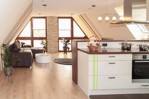 a kitchen and living room with a couch at Hotel & Restaurant Waldblick in Pulsnitz