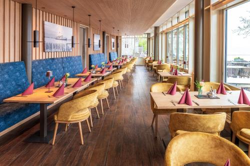 a row of tables and chairs in a restaurant at Schloss Hotel Wasserburg in Wasserburg