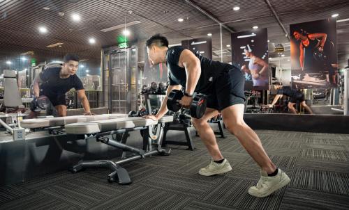 two men in a gym working out on a treadmill at GM Premium Hotel in Hanoi