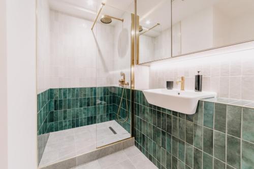 a bathroom with a sink and a shower at Luxury Two Bedroom Birmingham City Centre Apartment in Birmingham
