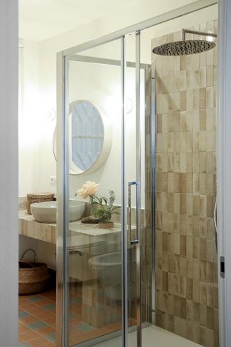 a bathroom with a glass shower with a sink at Flowers Rooms - Ponte Milvio in Rome