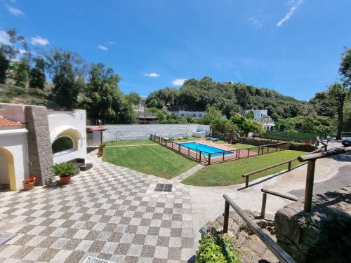 a house with a swimming pool and a yard at Villa Casa Caruso in Ischia